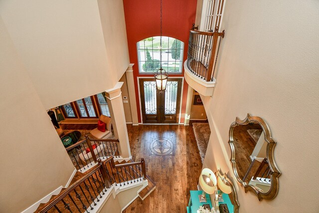 902 Delford Way, Sugar Land, TX 77479 - foyer featuring wood finished floors, a chandelier, stairway, a high ceiling, and baseboards