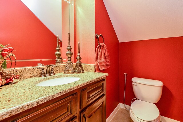 902 Delford Way, Sugar Land, TX 77479 - bathroom with vanity, vaulted ceiling, toilet, tile patterned floors, and baseboards