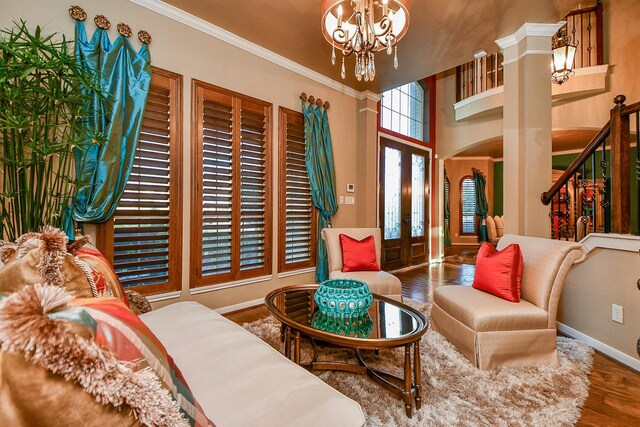 902 Delford Way, Sugar Land, TX 77479 - living room with a chandelier, baseboards, french doors, wood finished floors, and crown molding