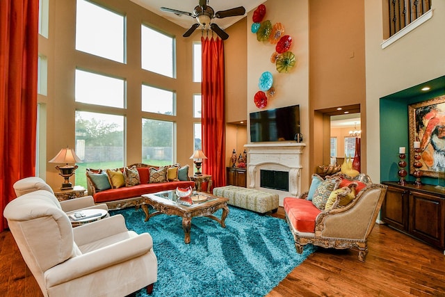 902 Delford Way, Sugar Land, TX 77479 - living room with a high ceiling, wood finished floors, ceiling fan, and a fireplace