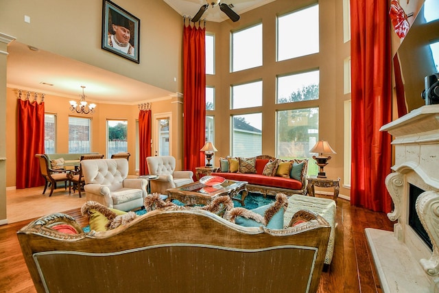 902 Delford Way, Sugar Land, TX 77479 - living room featuring ornamental molding, a chandelier, a premium fireplace, ceiling fan, and wood finished floors