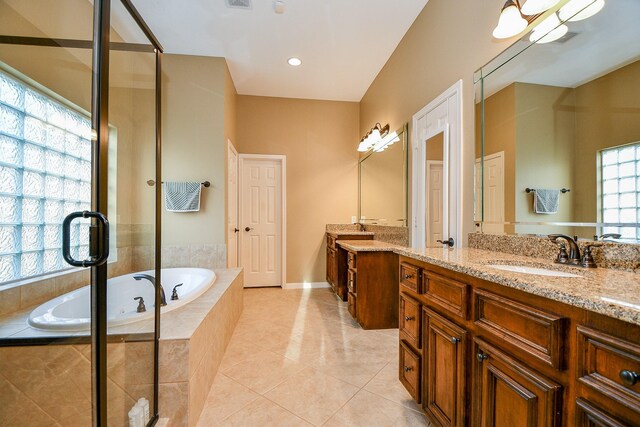 902 Delford Way, Sugar Land, TX 77479 - bathroom with two vanities, a bath, tile patterned floors, a shower stall, and baseboards