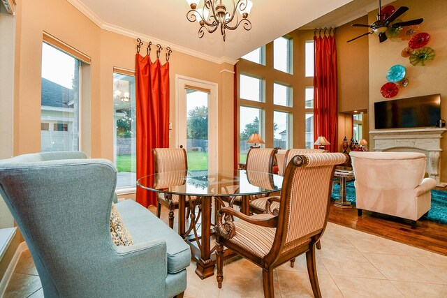 902 Delford Way, Sugar Land, TX 77479 - dining area with crown molding, healthy amount of natural light, a chandelier, tile patterned flooring, and a ceiling fan