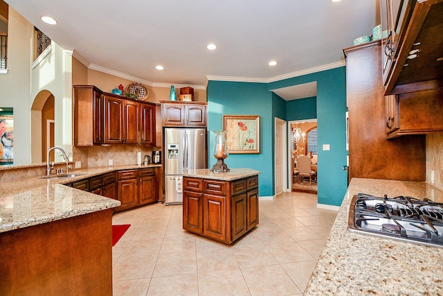 902 Delford Way, Sugar Land, TX 77479 - kitchen featuring a sink, appliances with stainless steel finishes, light stone counters, backsplash, and crown molding