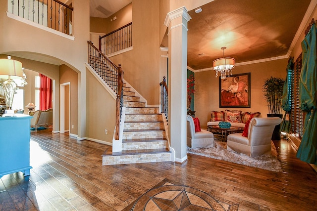 902 Delford Way, Sugar Land, TX 77479 - foyer entrance with a chandelier, wood-type flooring, arched walkways, stairway, and ornamental molding