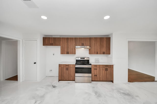5419 N Crooked Creek Dr, Houston, TX 77017 - kitchen featuring stainless steel electric range oven, under cabinet range hood, light countertops, brown cabinetry, and recessed lighting