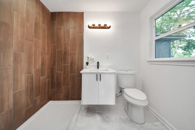 5419 N Crooked Creek Dr, Houston, TX 77017 - bathroom featuring vanity, baseboards, toilet, and tiled shower