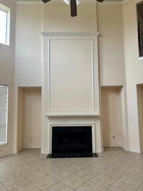 3003 Mystic Frst, Missouri City, TX 77459 - detailed view of a fireplace with flush hearth, ceiling fan, baseboards, and ornamental molding