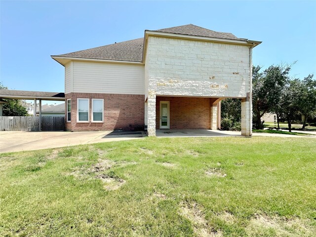 3003 Mystic Frst, Missouri City, TX 77459 - rear view of house featuring a patio, a shingled roof, and stone siding