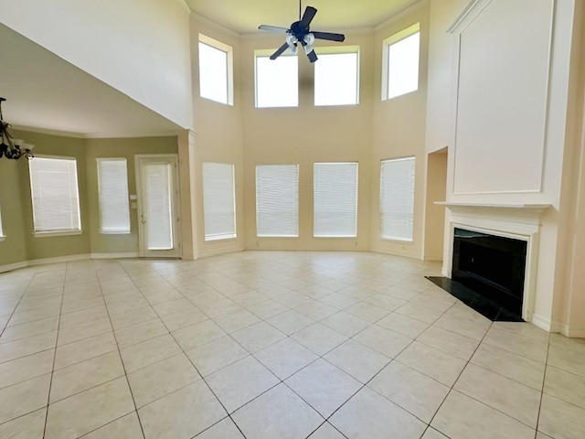 3003 Mystic Frst, Missouri City, TX 77459 - unfurnished living room with ceiling fan, light tile patterned flooring, a fireplace with flush hearth, and a high ceiling