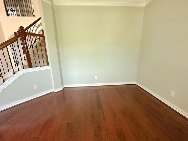 3003 Mystic Frst, Missouri City, TX 77459 - spare room featuring crown molding, wood finished floors, baseboards, and stairway