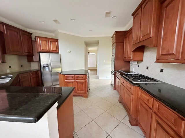 3003 Mystic Frst, Missouri City, TX 77459 - kitchen featuring appliances with stainless steel finishes, a kitchen island, decorative backsplash, ornamental molding, and light tile patterned floors