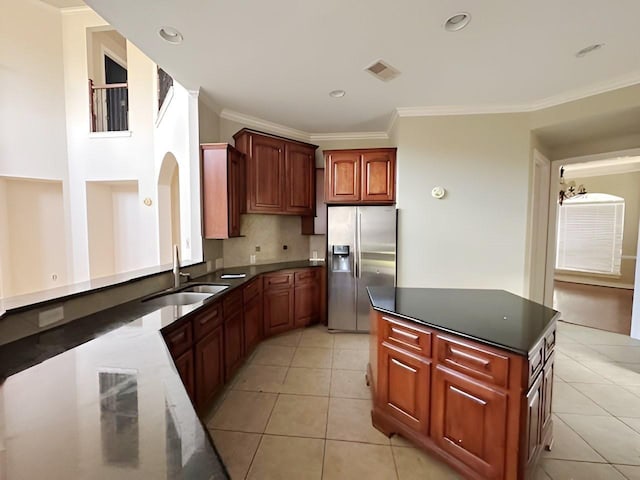 3003 Mystic Frst, Missouri City, TX 77459 - kitchen featuring stainless steel fridge with ice dispenser, a sink, crown molding, light tile patterned floors, and dark countertops
