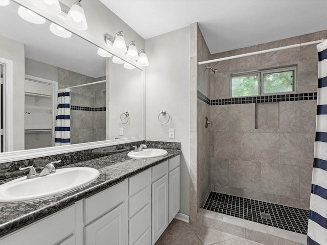 2234 Naomi St, Houston, TX 77054 - bathroom with tiled shower, double vanity, and tile patterned floors