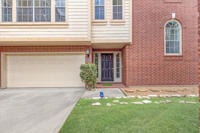 2263 Austin St, Houston, TX 77002 - property entrance with driveway, brick siding, and an attached garage
