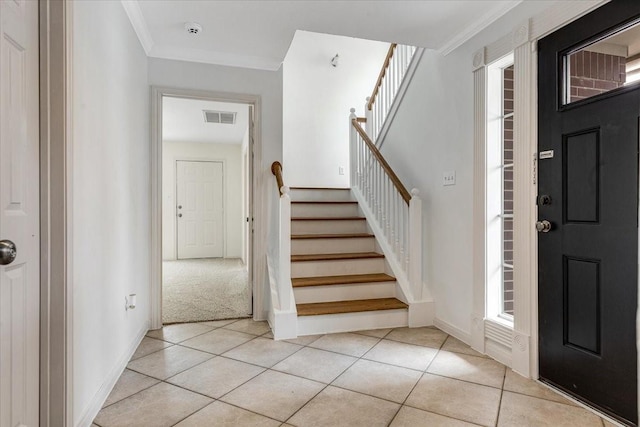 2263 Austin St, Houston, TX 77002 - foyer with stairway, light tile patterned floors, crown molding, and baseboards