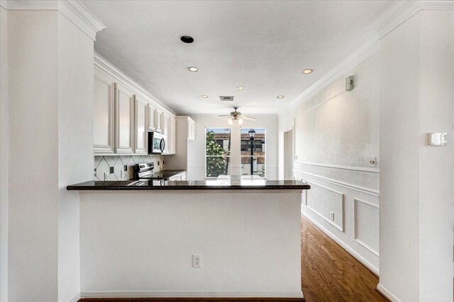 2263 Austin St, Houston, TX 77002 - kitchen with appliances with stainless steel finishes, dark countertops, ornamental molding, tasteful backsplash, and recessed lighting