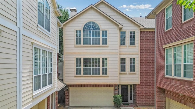 2263 Austin St, Houston, TX 77002 - rear view of house featuring a garage, brick siding, and driveway