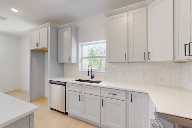176 Kaelepulu Dr, Bastrop, TX 78602 - kitchen featuring stainless steel appliances, a sink, decorative backsplash, light wood-type flooring, and light countertops