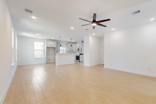 176 Kaelepulu Dr, Bastrop, TX 78602 - unfurnished living room with ceiling fan, recessed lighting, baseboards, and light wood-type flooring