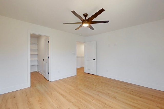 176 Kaelepulu Dr, Bastrop, TX 78602 - empty room featuring a ceiling fan, light wood-style floors, and baseboards