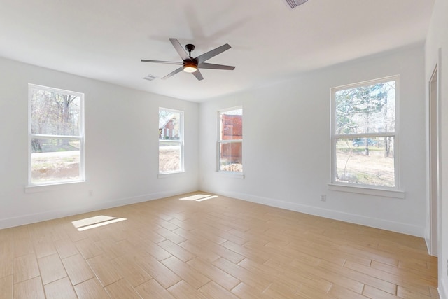 176 Kaelepulu Dr, Bastrop, TX 78602 - unfurnished room featuring plenty of natural light, a ceiling fan, light wood-type flooring, and baseboards