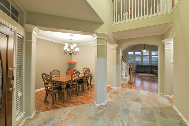13814 Swan Hollow Ln, Houston, TX 77041 - dining space featuring stone tile floors, ornate columns, arched walkways, stairs, and ornamental molding