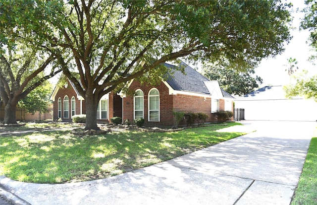 14103 Owens Rd, Houston, TX 77095 - view of front of home with brick siding, a front lawn, and a shingled roof