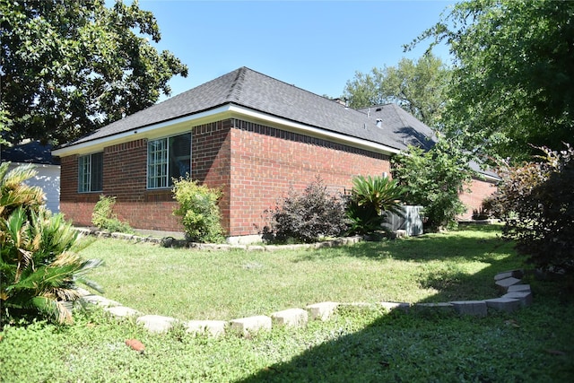 14103 Owens Rd, Houston, TX 77095 - view of side of property featuring brick siding, a yard, and a shingled roof