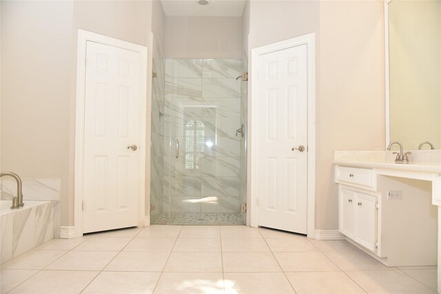 14103 Owens Rd, Houston, TX 77095 - full bathroom with a marble finish shower, a garden tub, vanity, tile patterned floors, and baseboards