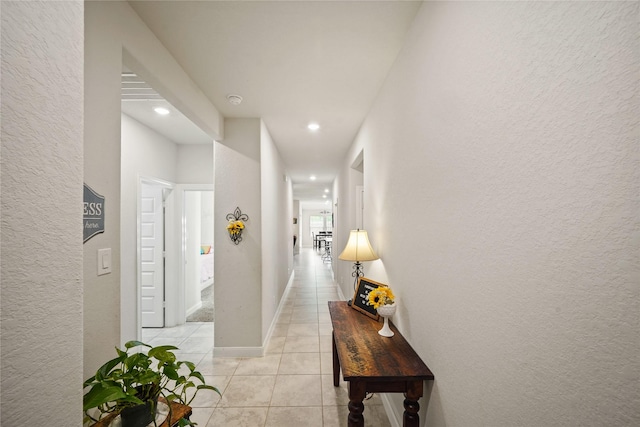 11607 Brookside Arbor Ln, Richmond, TX 77406 - hall with light tile patterned floors, a textured wall, recessed lighting, and baseboards