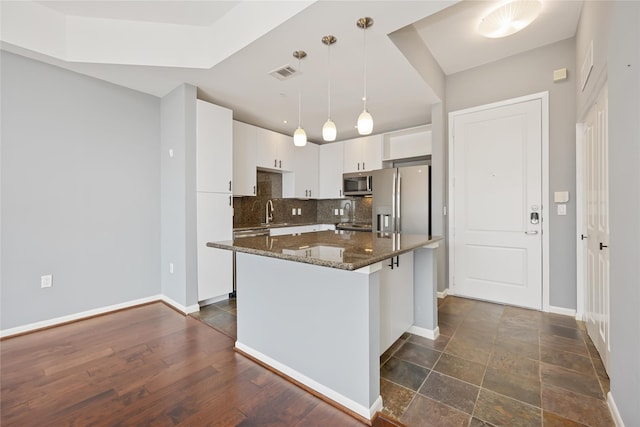 3505 Sage Rd Unit 1508, Houston, TX 77056 - kitchen with appliances with stainless steel finishes, backsplash, white cabinetry, baseboards, and dark stone countertops