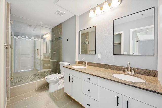3505 Sage Rd Unit 1508, Houston, TX 77056 - bathroom featuring a shower stall, double vanity, toilet, and tile patterned floors