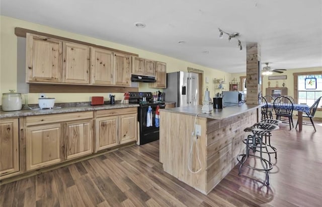 2000 E Beverly Dr, Shepherd, TX 77371 - kitchen with black electric range oven, stainless steel refrigerator with ice dispenser, under cabinet range hood, and light brown cabinets