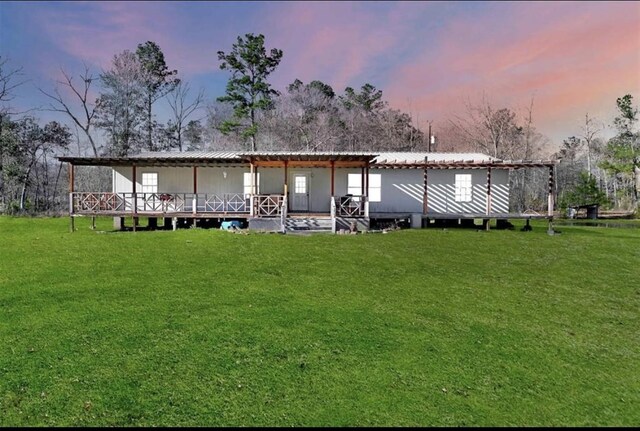 2000 E Beverly Dr, Shepherd, TX 77371 - back of house featuring a lawn and metal roof