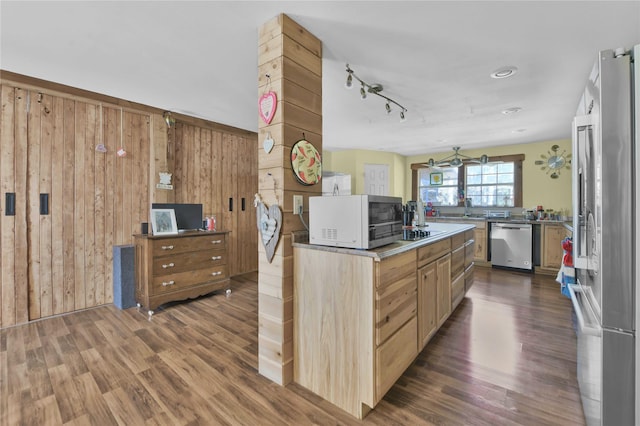 2000 E Beverly Dr, Shepherd, TX 77371 - kitchen featuring appliances with stainless steel finishes, dark wood-style floors, wood walls, and a sink