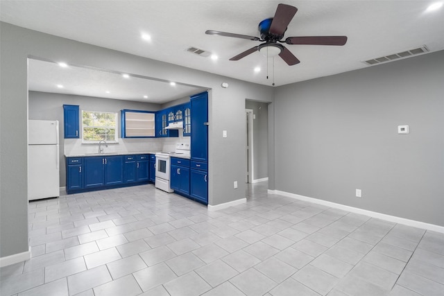 611 93rd St, Houston, TX 77012 - kitchen with white appliances, blue cabinets, a sink, ceiling fan, and light countertops