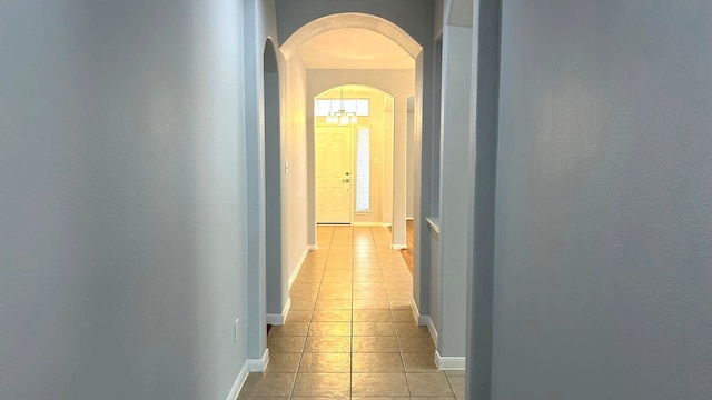 8106 Saragosa Blue Ln, Richmond, TX 77407 - corridor with arched walkways, light tile patterned floors, and baseboards