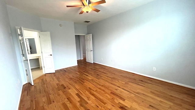 8106 Saragosa Blue Ln, Richmond, TX 77407 - unfurnished bedroom with wood finished floors, baseboards, and ceiling fan
