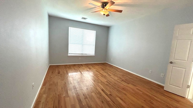 8106 Saragosa Blue Ln, Richmond, TX 77407 - empty room featuring a ceiling fan, wood finished floors, and baseboards