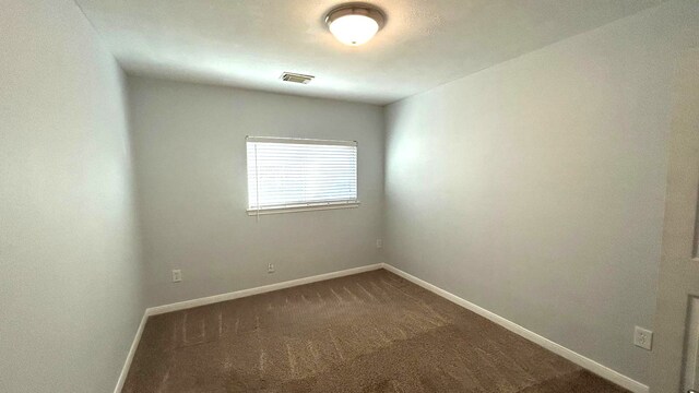 8106 Saragosa Blue Ln, Richmond, TX 77407 - spare room with dark carpet and baseboards
