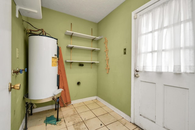 203 Kirkaldy Dr, Houston, TX 77015 - washroom featuring water heater, baseboards, hookup for an electric dryer, light tile patterned floors, and a textured ceiling