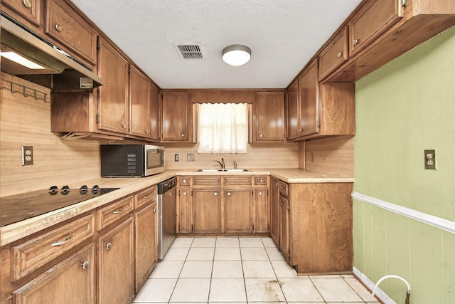 203 Kirkaldy Dr, Houston, TX 77015 - kitchen with stainless steel appliances, a sink, under cabinet range hood, light countertops, and brown cabinetry