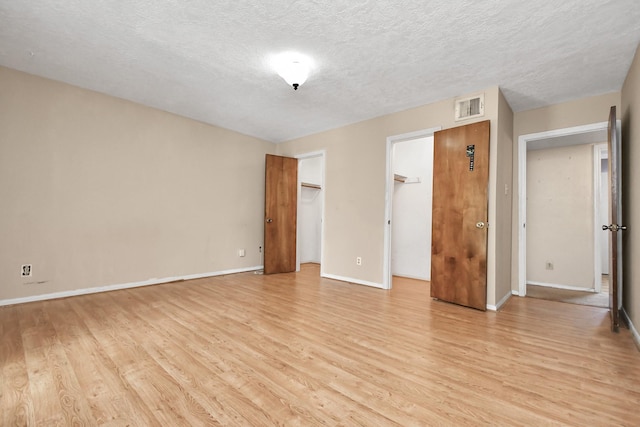 203 Kirkaldy Dr, Houston, TX 77015 - unfurnished room with light wood-style flooring, baseboards, and a textured ceiling