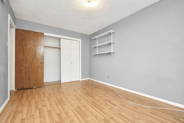 203 Kirkaldy Dr, Houston, TX 77015 - unfurnished bedroom with light wood-style floors, baseboards, and a closet