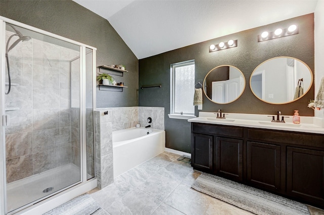 16715 Peralta Bay Cir, Crosby, TX 77532 - full bathroom with lofted ceiling, double vanity, a garden tub, a stall shower, and a textured wall