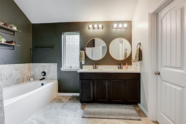 16715 Peralta Bay Cir, Crosby, TX 77532 - full bath featuring lofted ceiling, double vanity, a garden tub, a textured wall, and baseboards