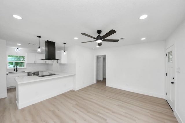 11503 Duane St, Houston, TX 77047 - kitchen featuring island range hood, a sink, recessed lighting, white cabinetry, and light wood-style flooring