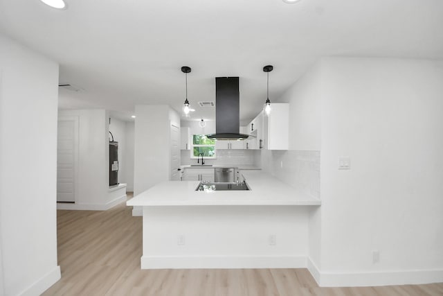 11503 Duane St, Houston, TX 77047 - kitchen with a sink, island exhaust hood, baseboards, white cabinets, and light countertops