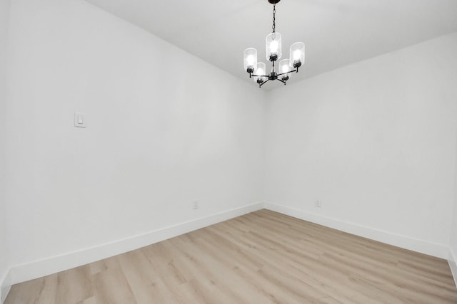 11503 Duane St, Houston, TX 77047 - unfurnished room featuring a chandelier, light wood-style floors, and baseboards